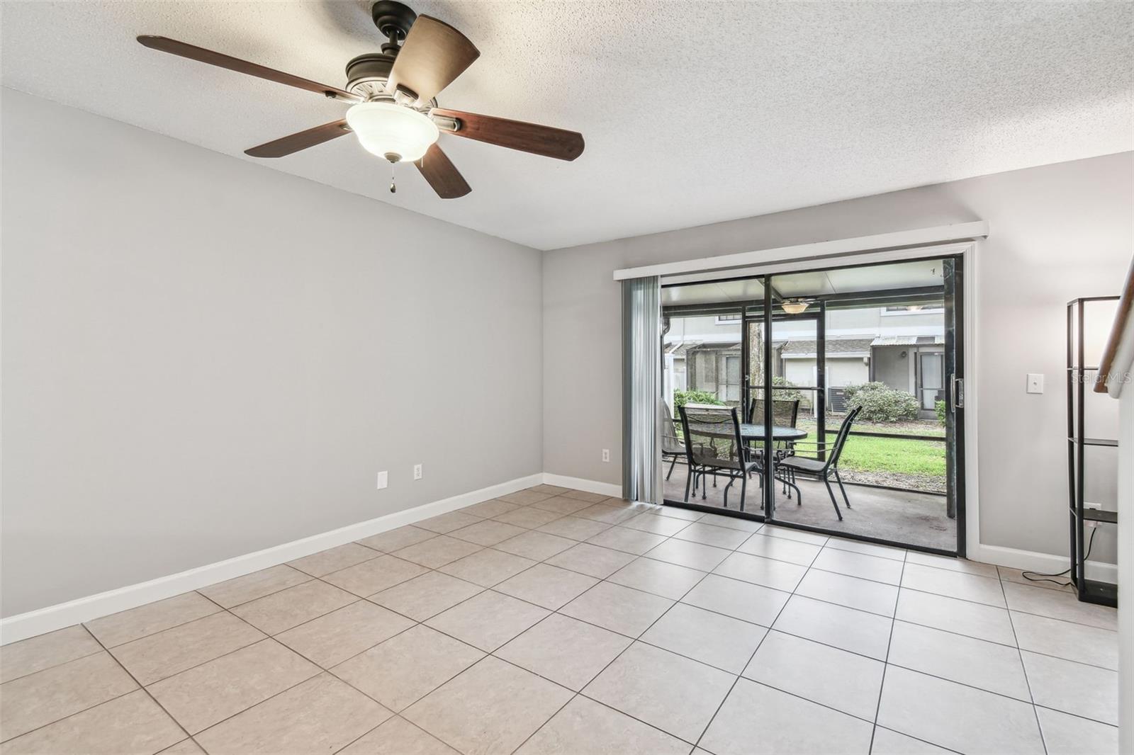 Living room has sliding doors leading to the outdoor covered lanai.