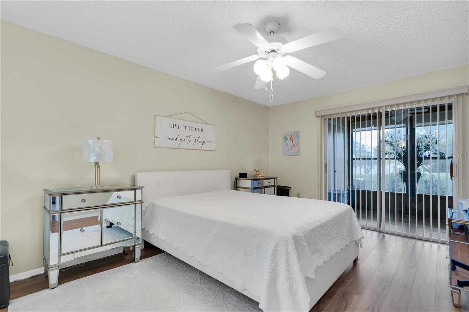 Primary bedroom with glass sliders to Florida Room