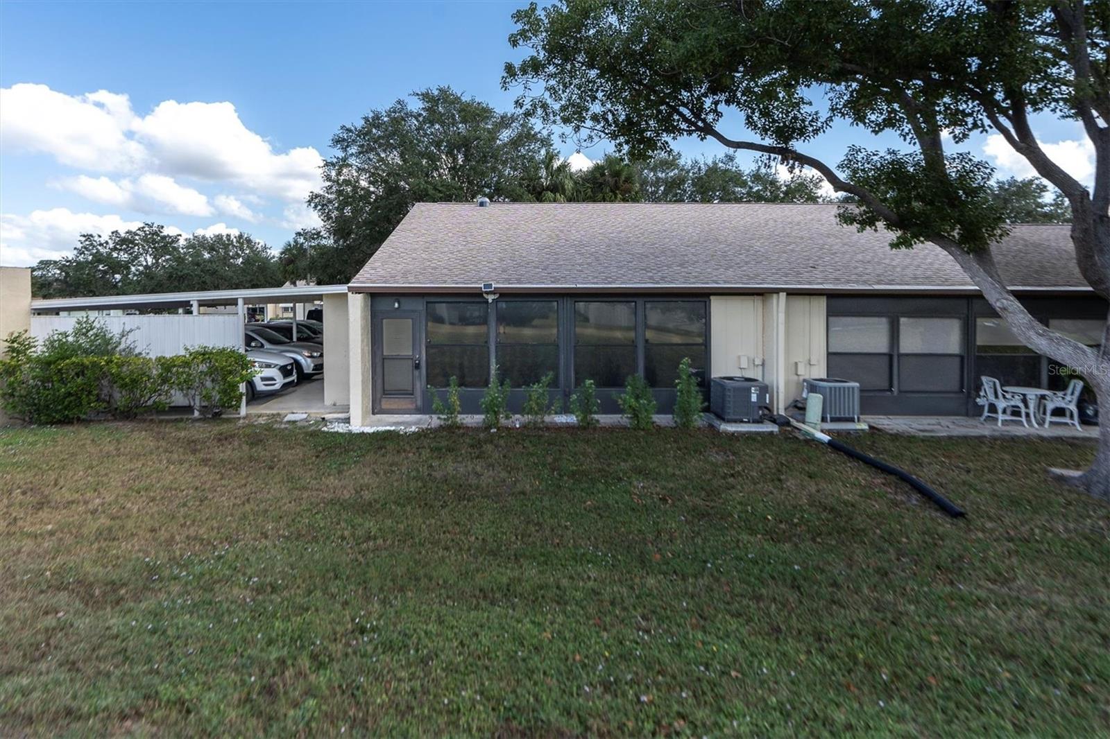 Rear view. End unit adjacent to covered parking