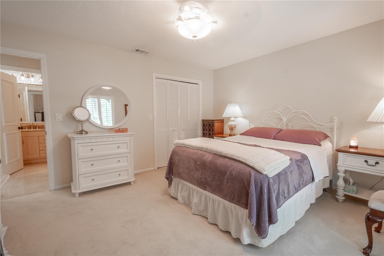 The 2nd bedroom features a built-in closet with shutter doors.