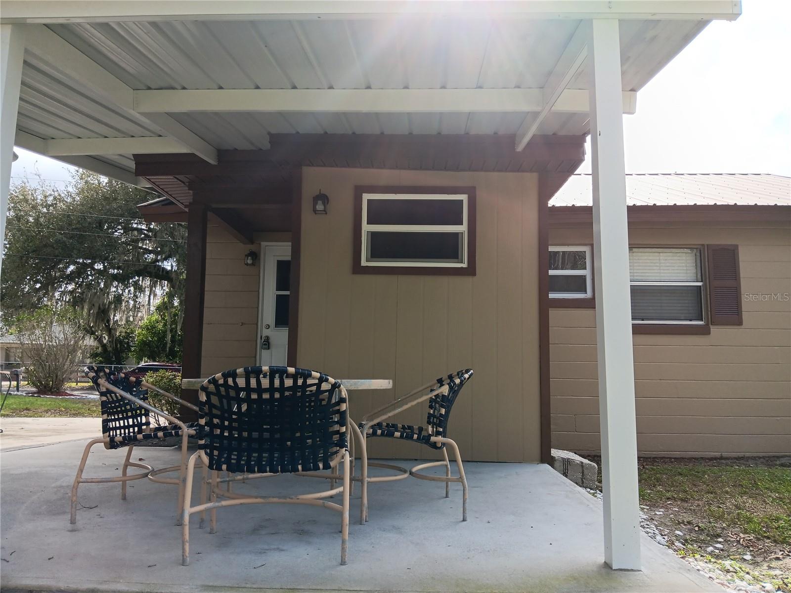 Concrete back deck with metal roof