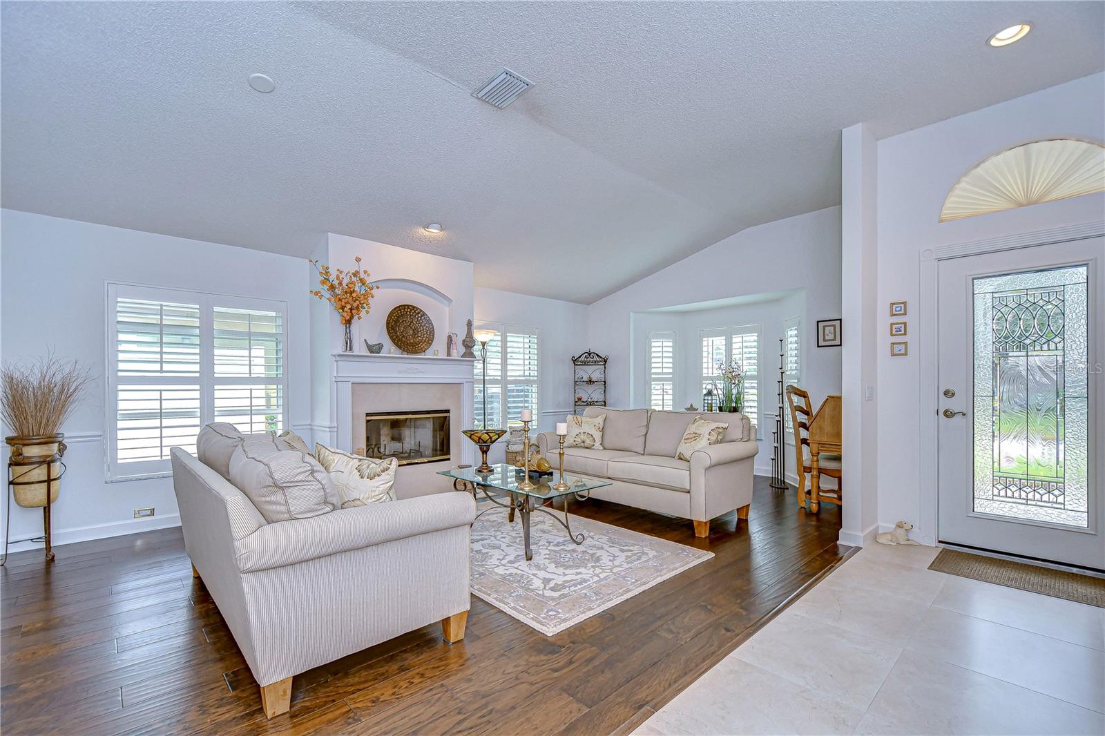 Formal living room has vaulted ceiling and fireplace!