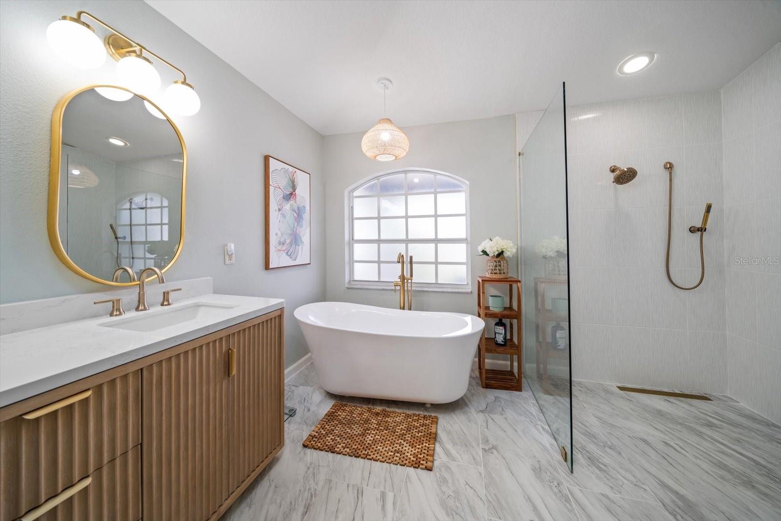 Double vanity and soaking tub and shower in primary bathroom