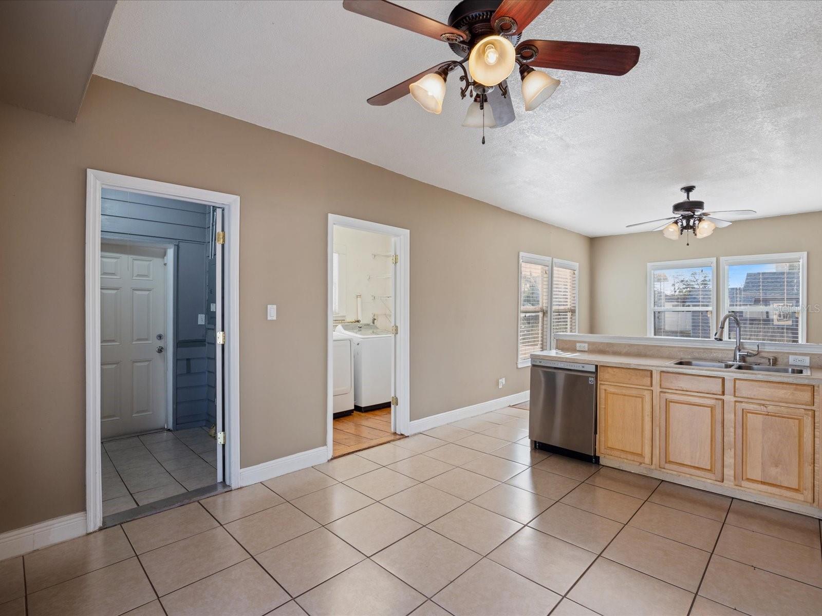 Kitchen looking towards side entry and mudroom along with laundry room