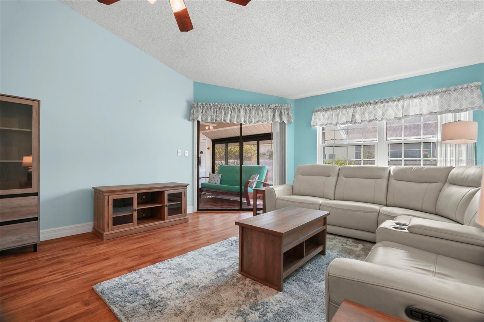 Siding doors lead to an enclosed screened lanai.