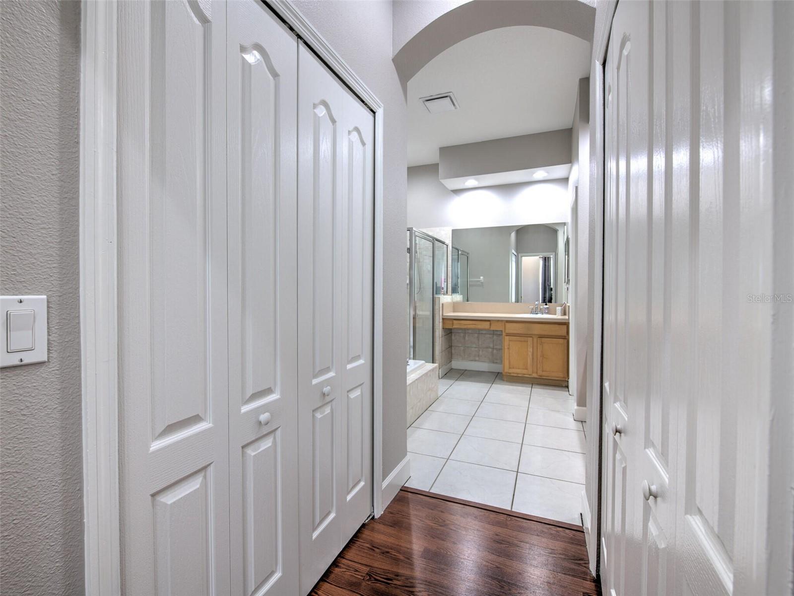 Primary bedroom hallway to en suite bathroom.walk-in and reach in closets