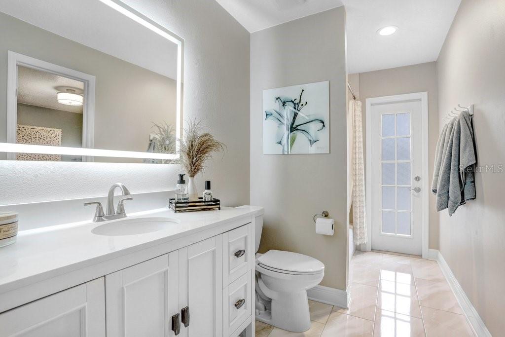 The Jack-n-Jill bathroom is completely updated and has a door to the pool and patio!