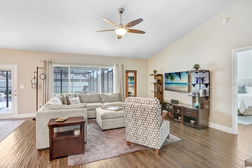 Main great room! There is ceramic plank tile flooring.....5-3/4 baseboards.....and high ceilings EVERYWHERE in the home!