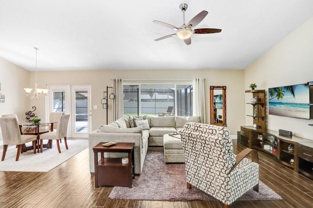 Main great room! There is ceramic plank tile flooring.....5-3/4 baseboards.....and high ceilings EVERYWHERE in the home!