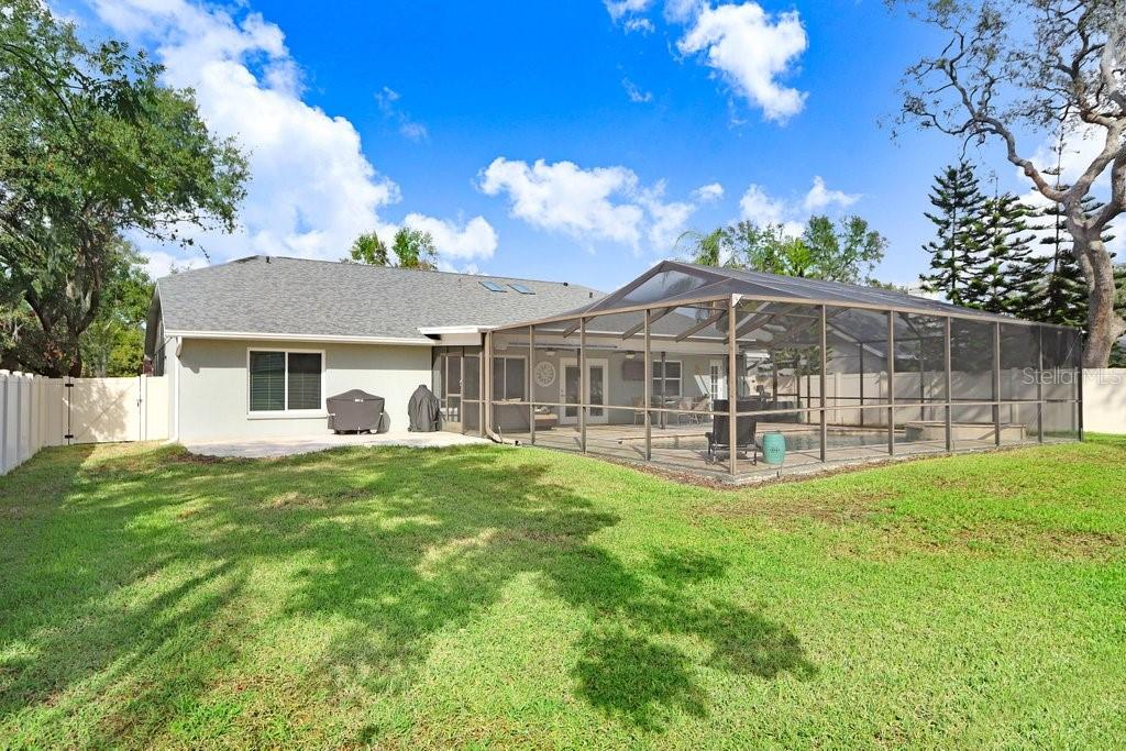 Great space beyond the screened patio for kids and fur babies to play!