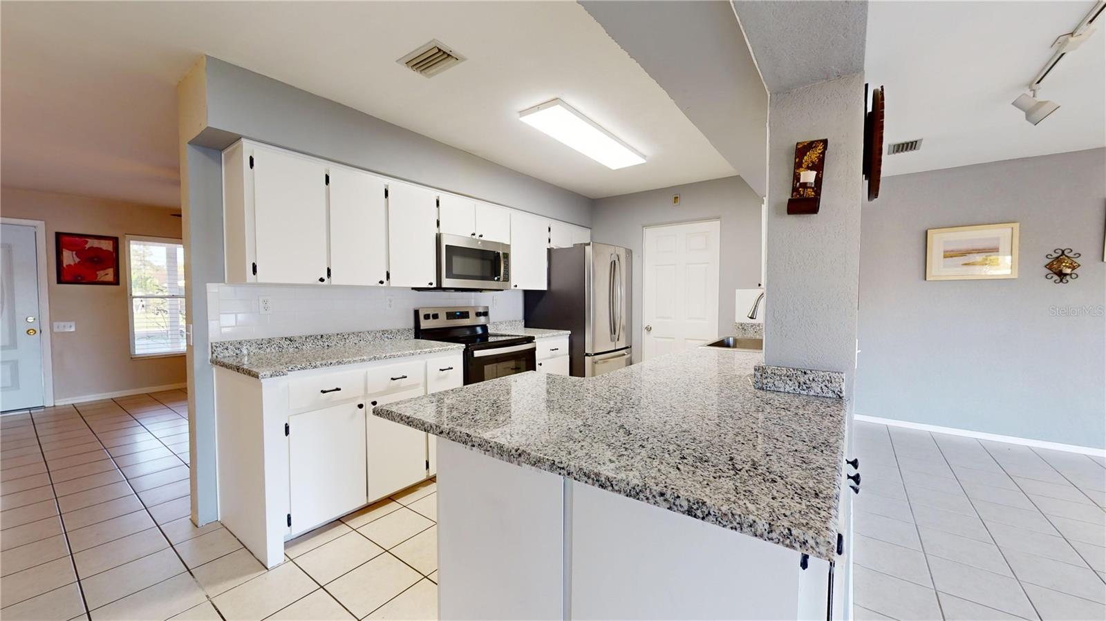 Kitchen with Living Room in Background