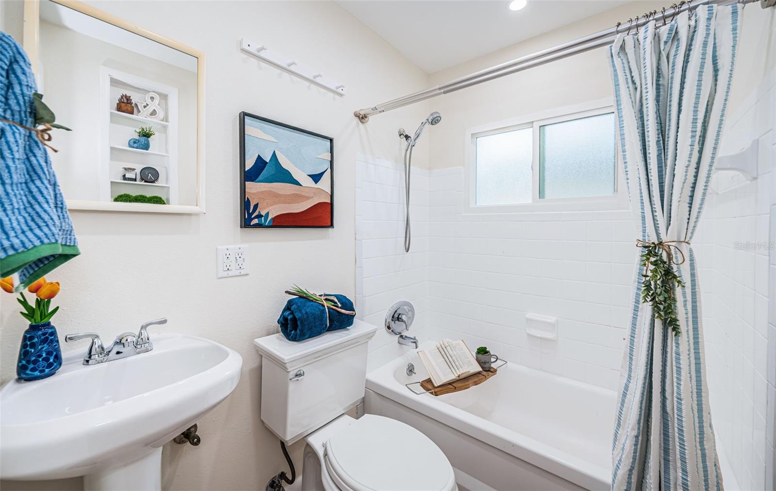 Cute bathroom with nice finishes and a window for natural light.