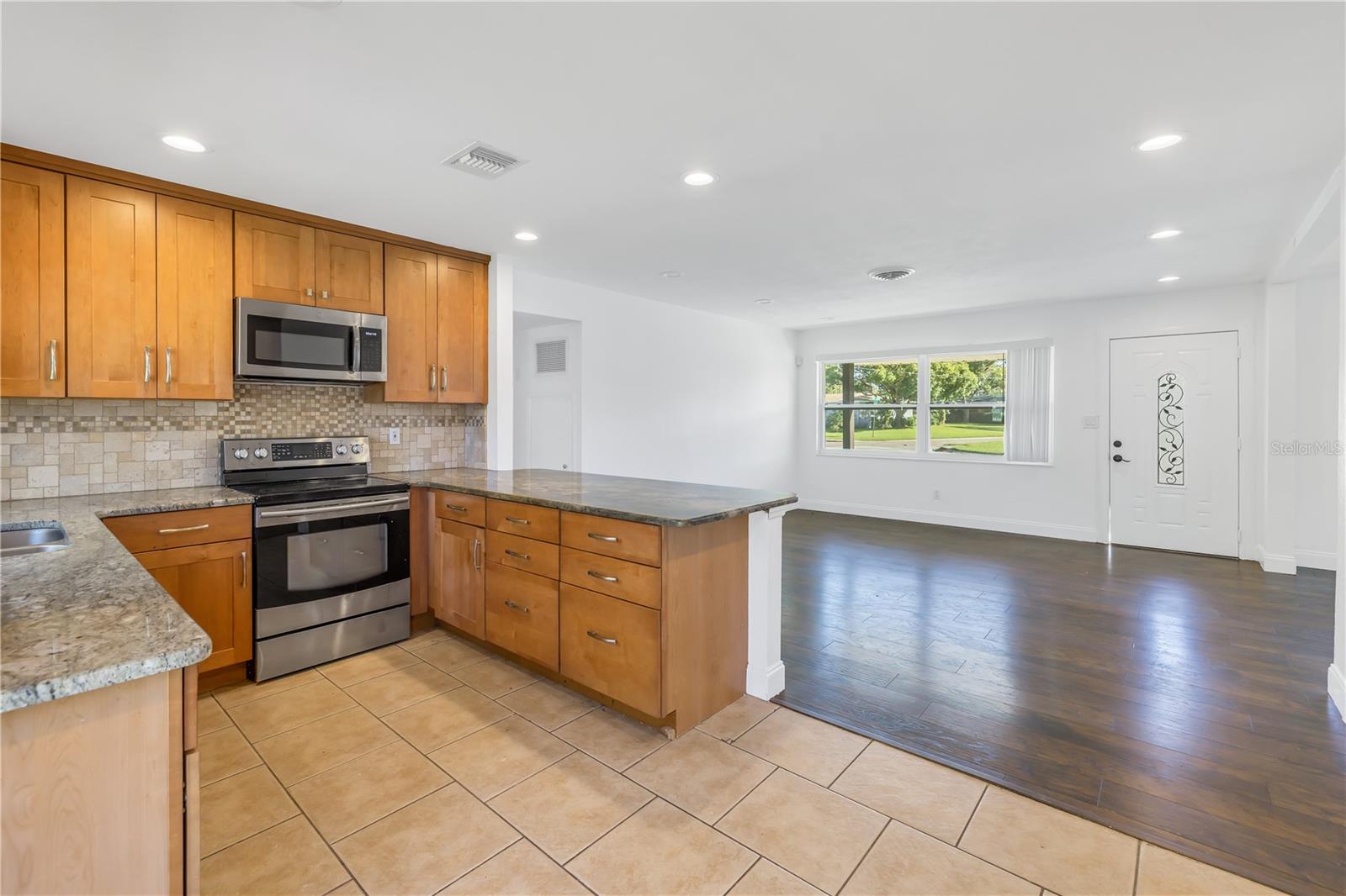 Kitchen boasts granite counter tops and stainless steel appliances.