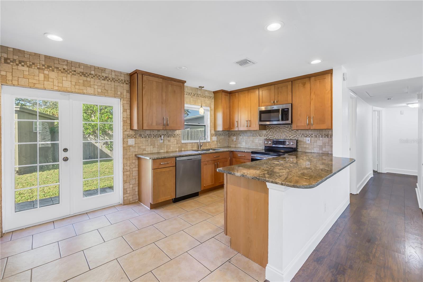 Kitchen and double doors leading to the back yard.