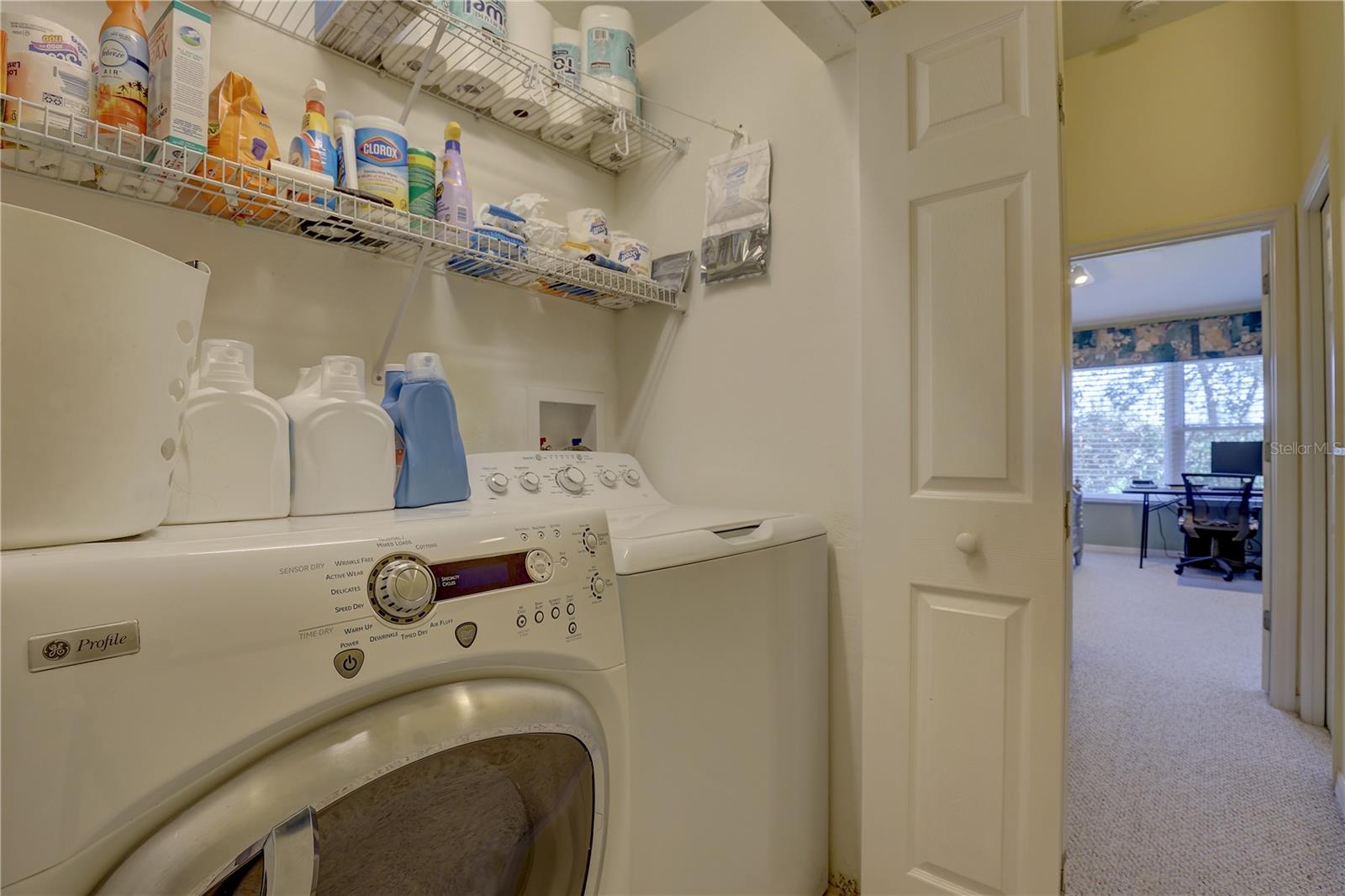 Inside laundry with storage