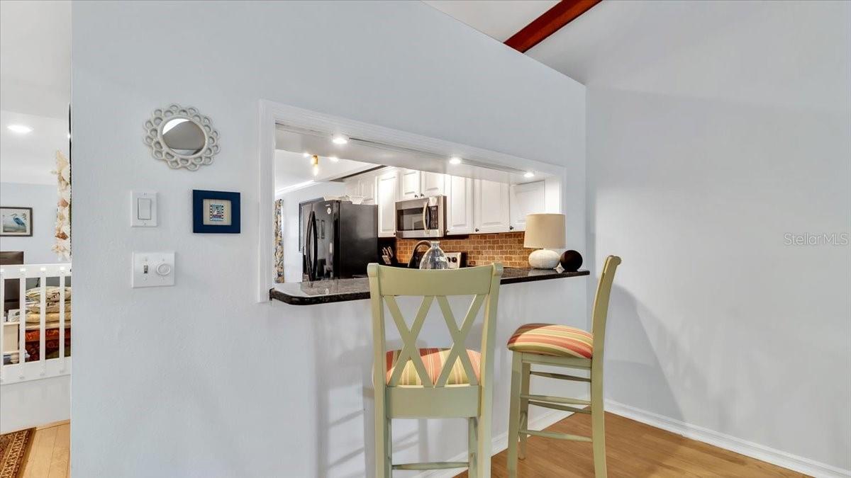 Breakfast bar with granite countertops.