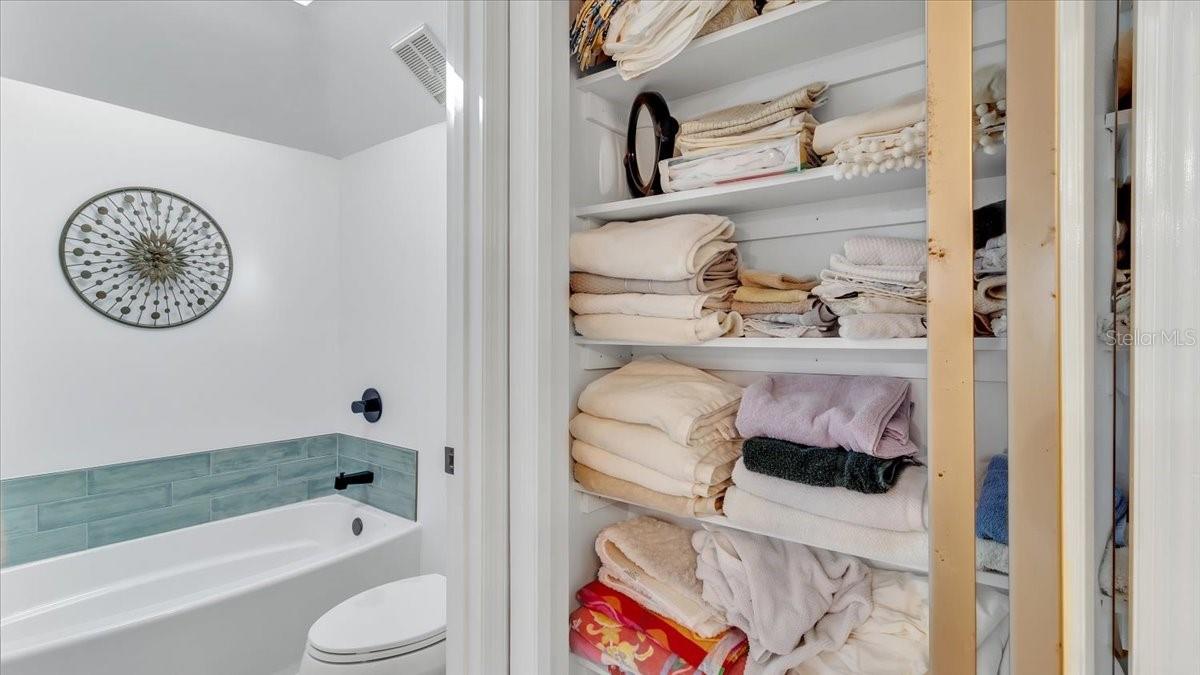 Giant linen closet in master bathroom.