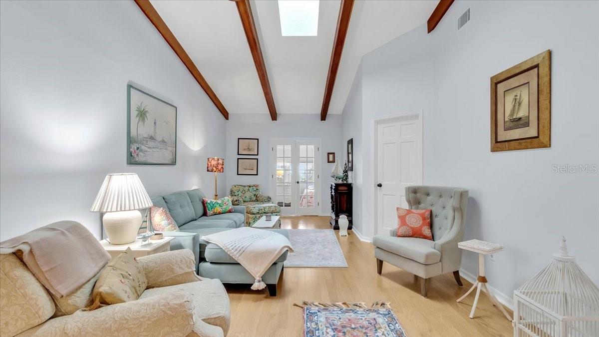 HUGE living room with vaulted ceilings, gorgeous wood beams and brand new skylight.