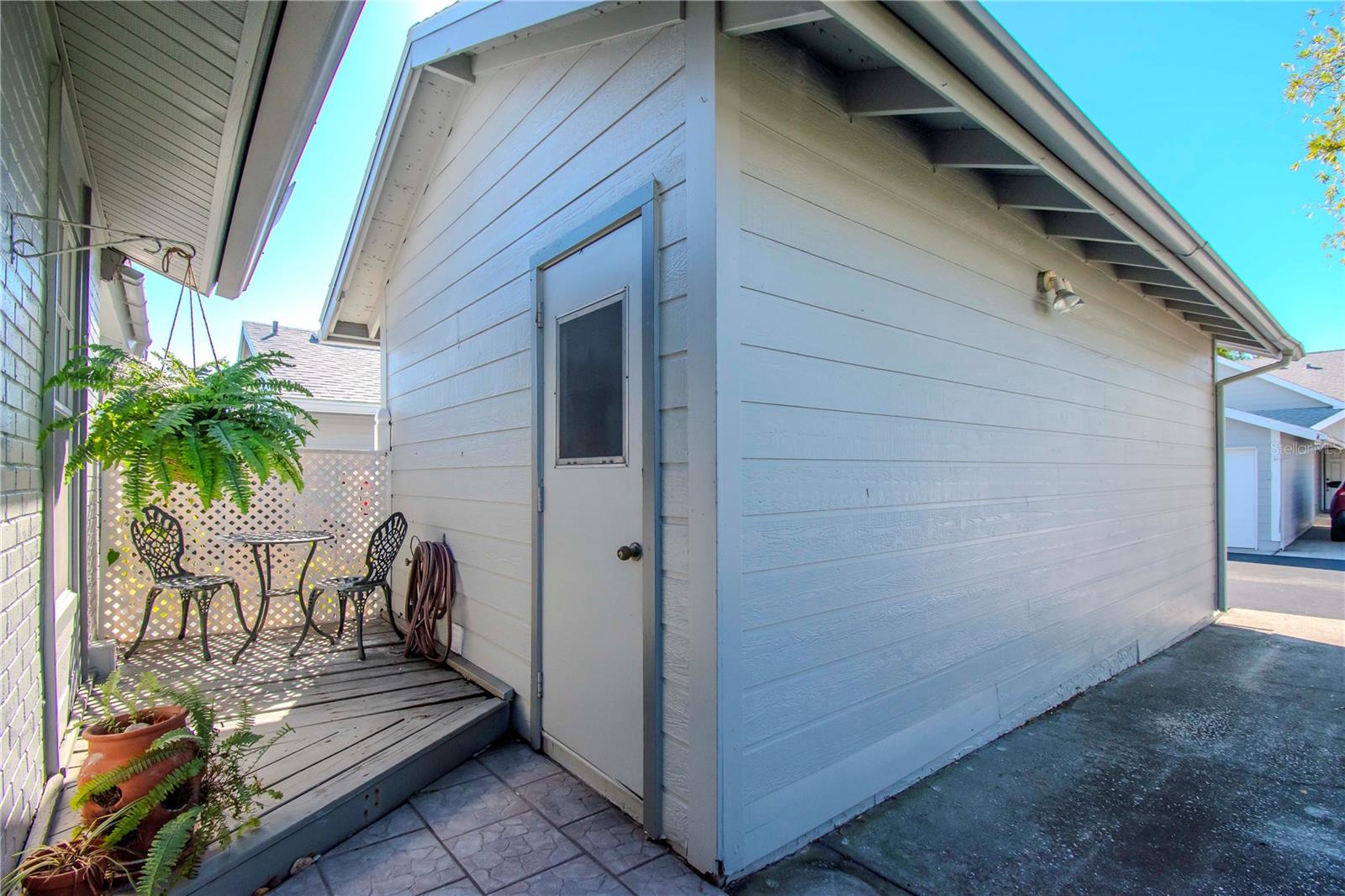 Entrance to garage and small porch in front of villa.