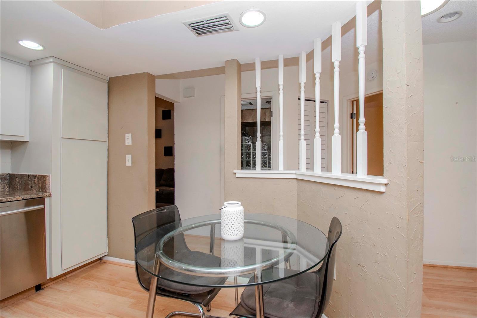 Half wall located in kitchen and view of the front door and 2nd bath.