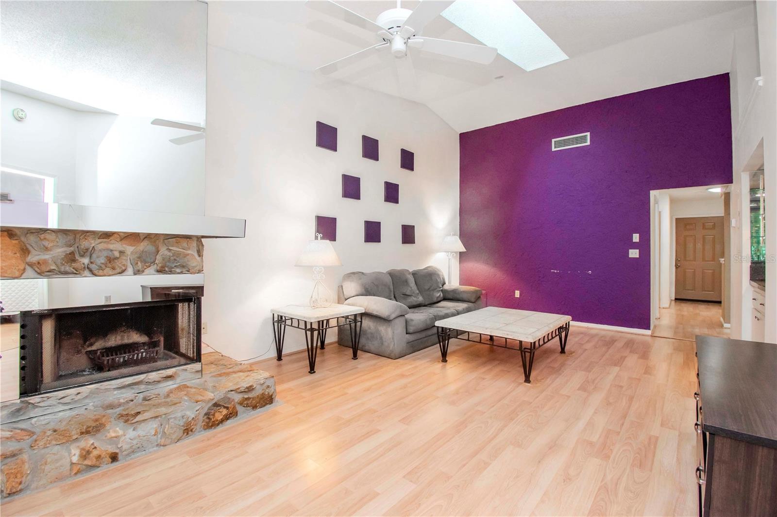 Living room with view to the front door.  Home has a split floor plan with one bed and bath in the front of the villa and the primary bed/bath in the back.