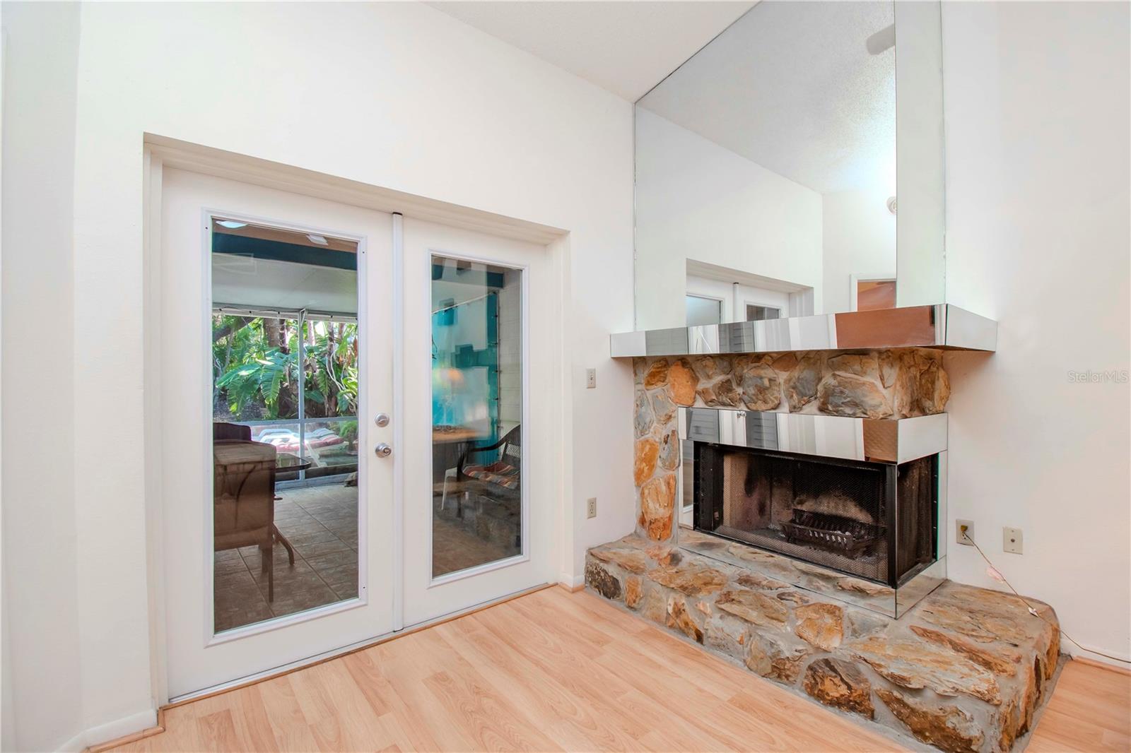 Wood burning fireplace and double doors the the enclosed back porch and fenced yard.