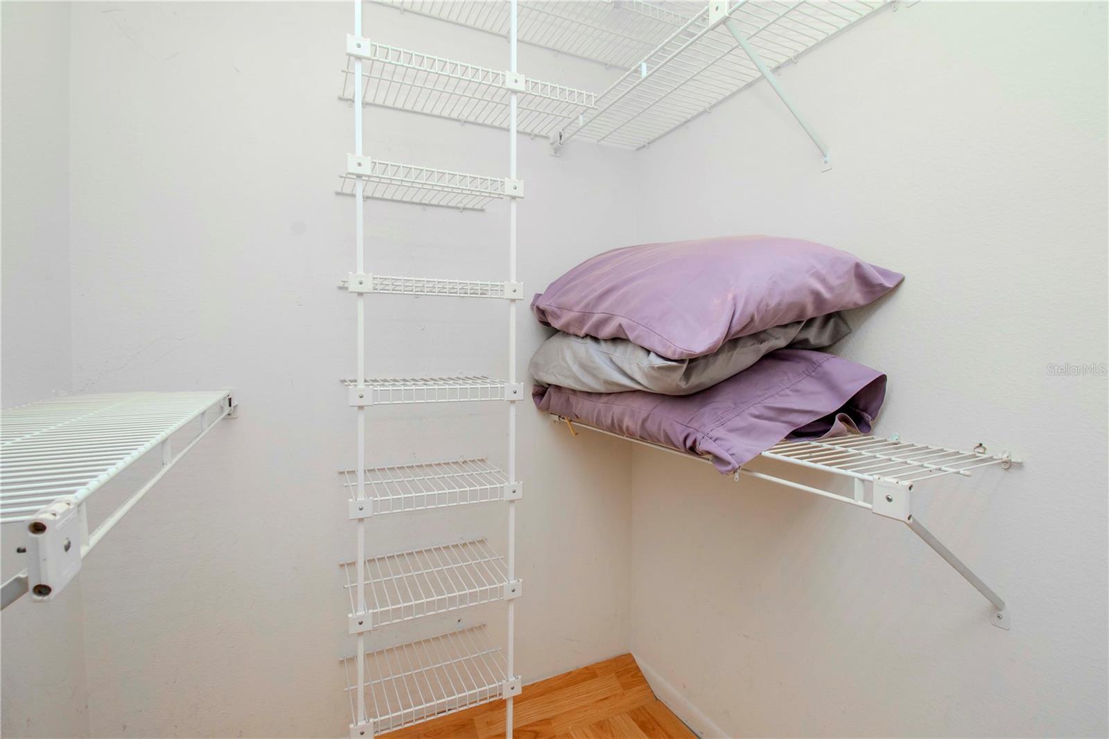 Primary bedroom walk in closet