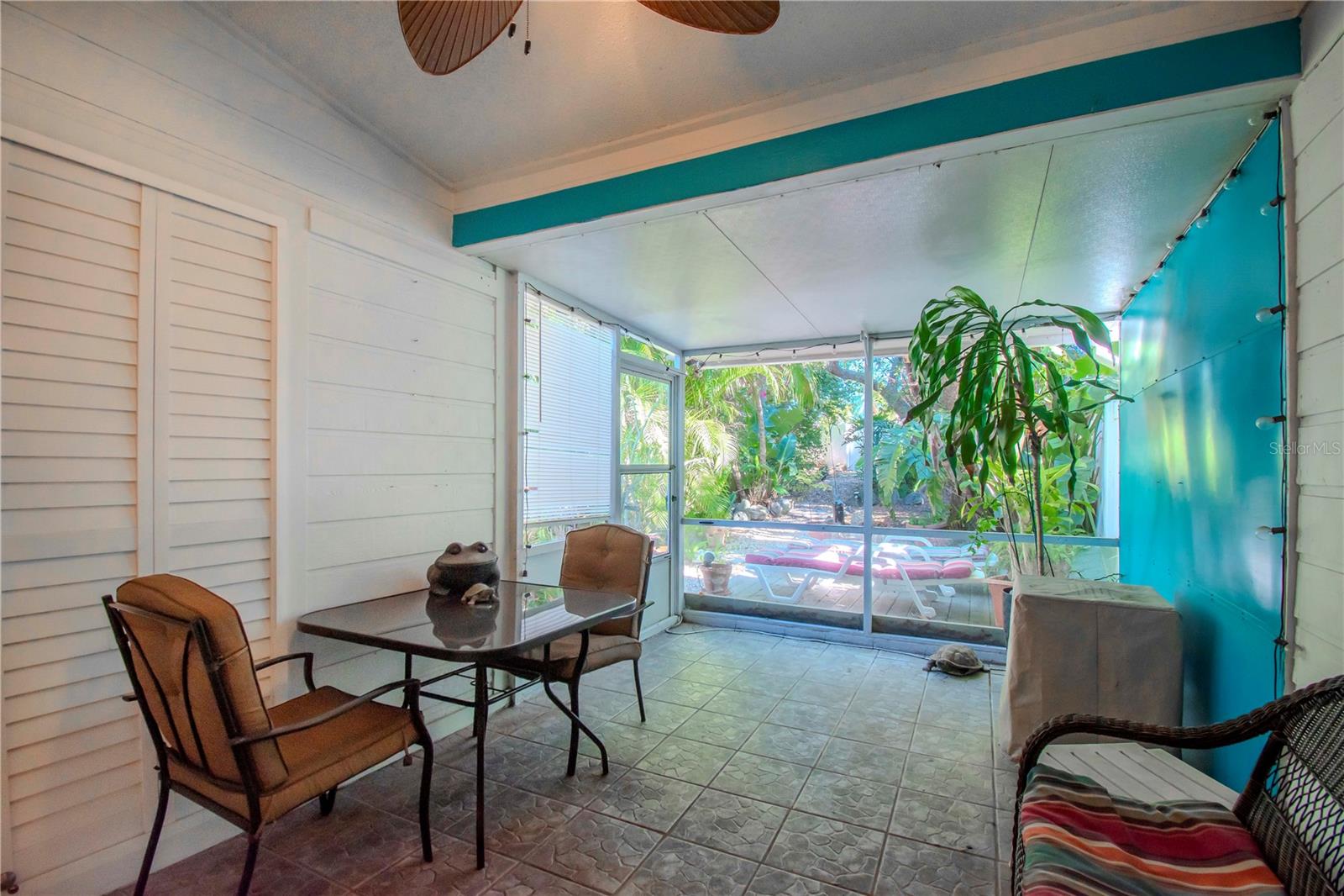 Enclosed back porch, behind the shutters is a sliding door that opens to the primary bedroom