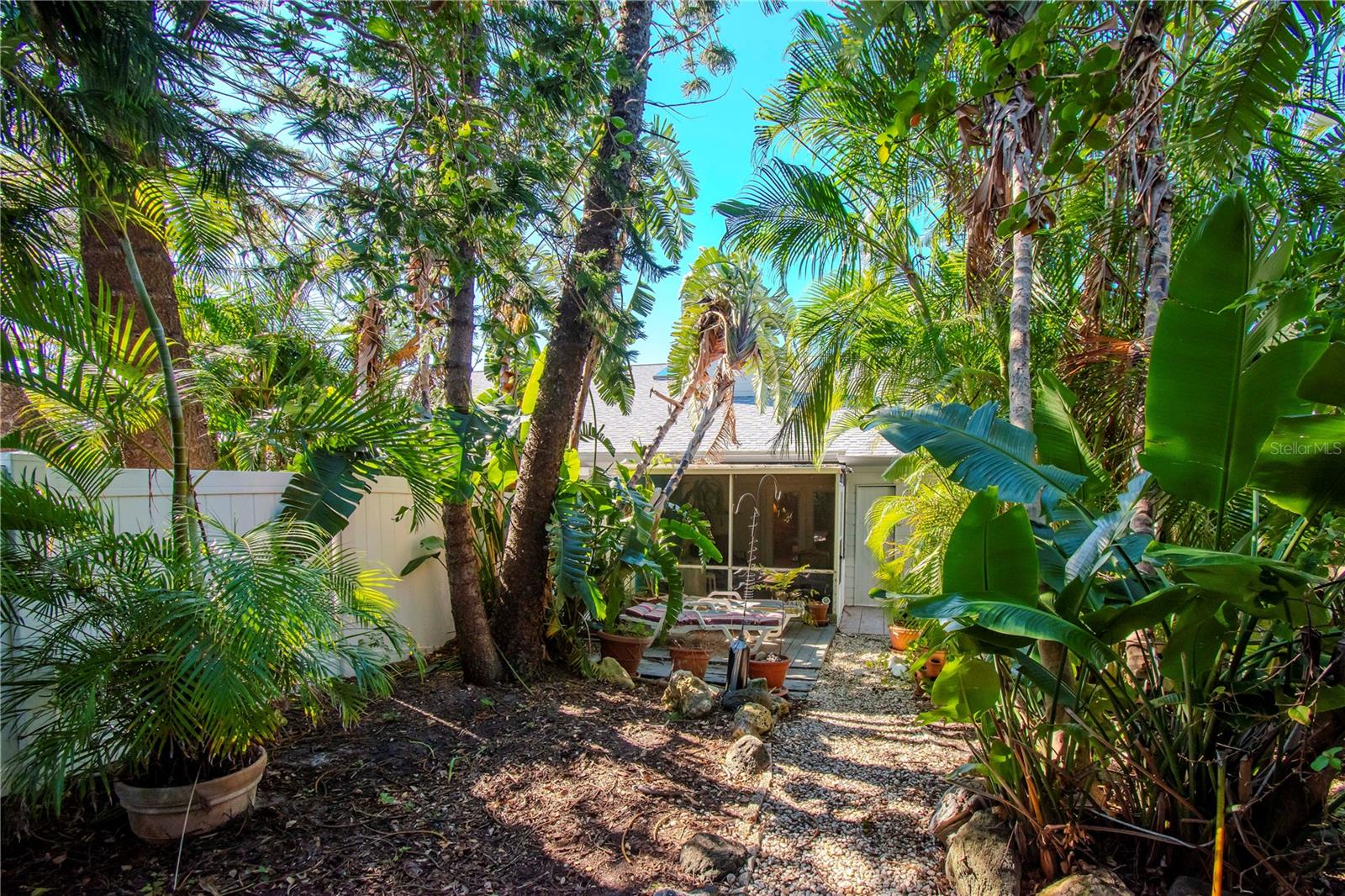 beautifully landscaped fenced in backyard.