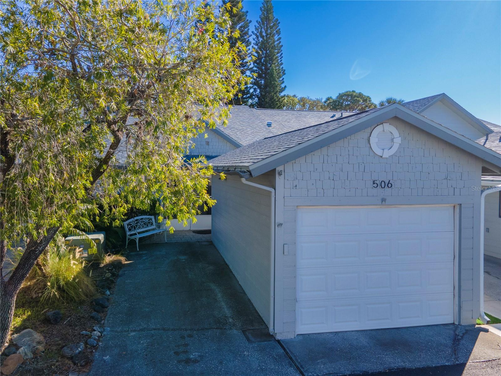 Driveway area and single car garage.  Laundry is located inside the garage.