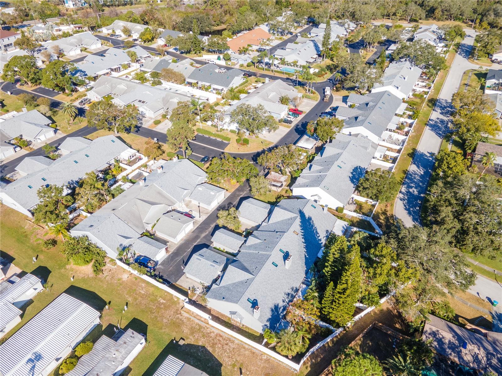 Aerial view of the unit and the backyard and street behind.