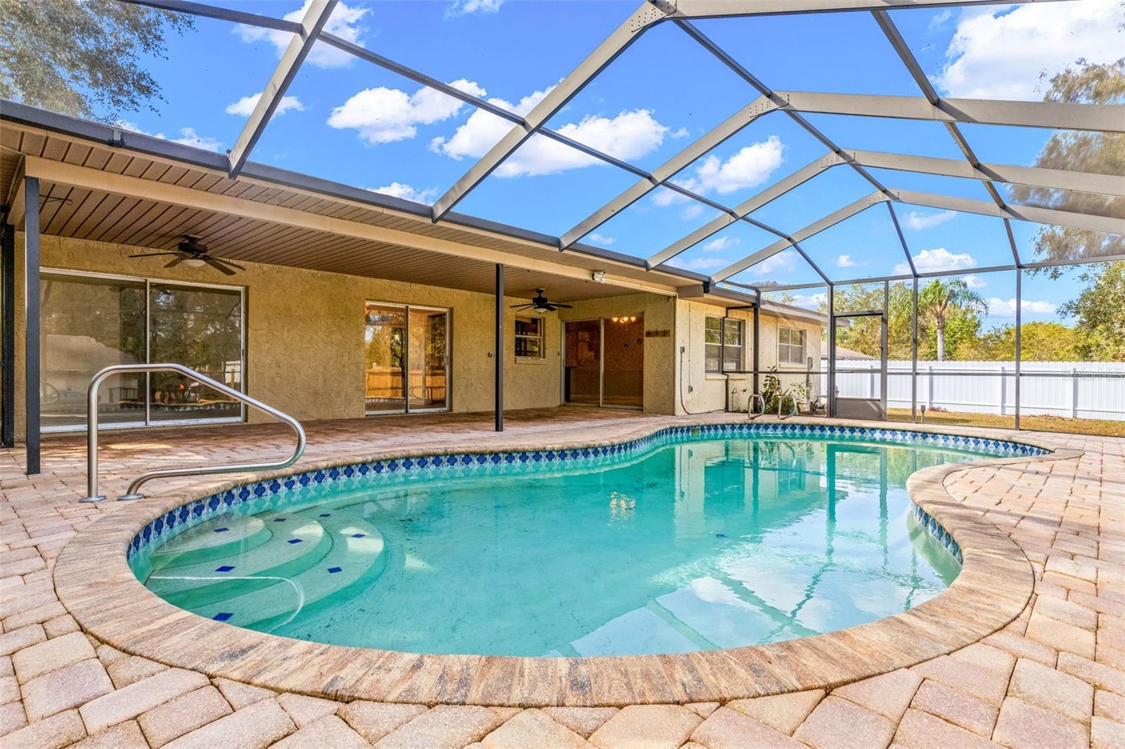 Pool with pavers and screened lanai