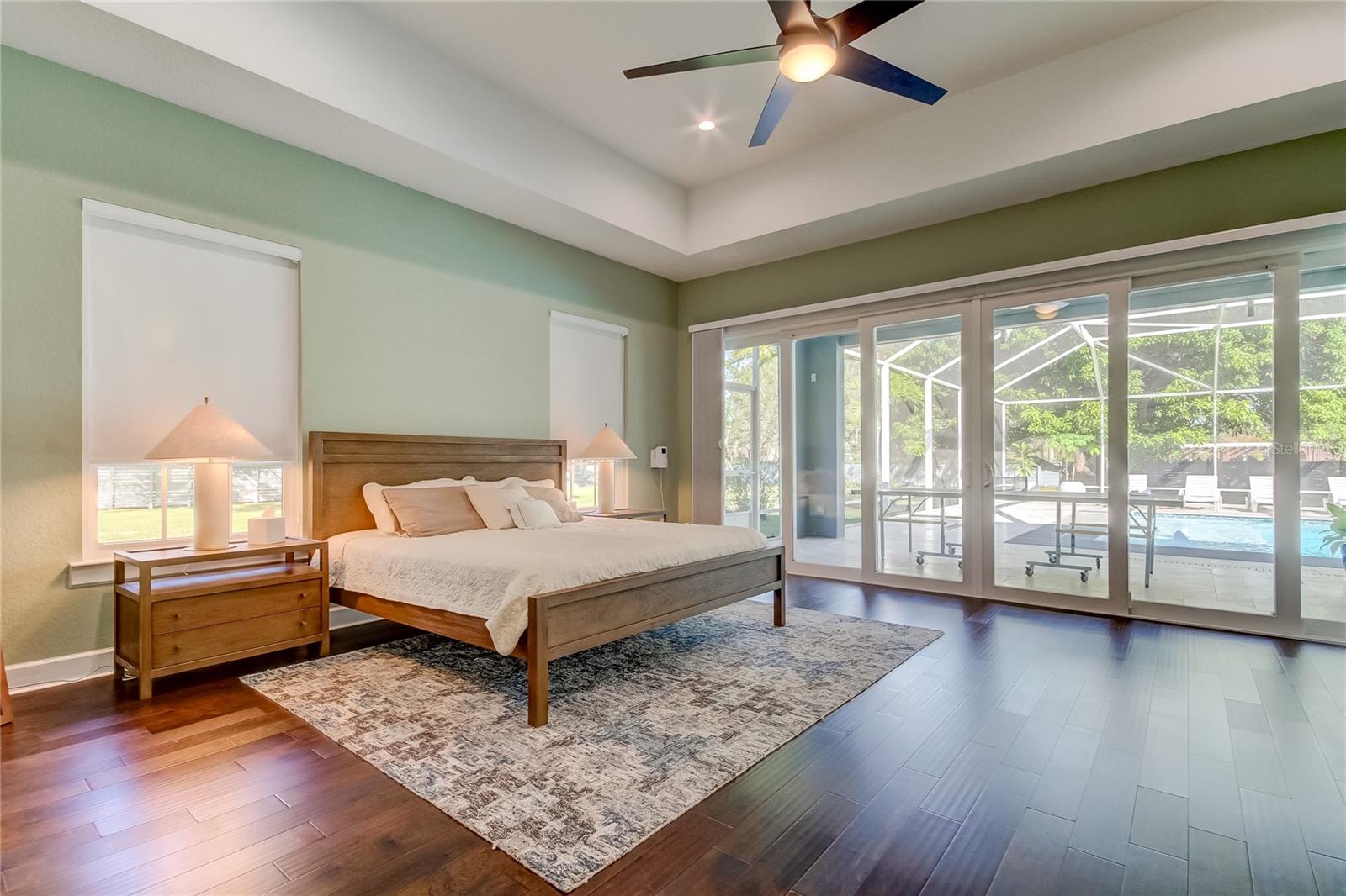 Primary bedroom suite overlooking pool