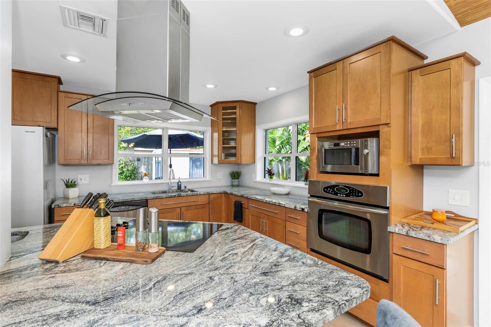 Updated kitchen with island glass cook top