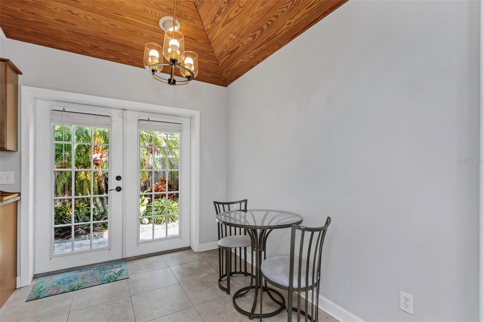 Eat-in kitchen with French doors to the pool and patio area.