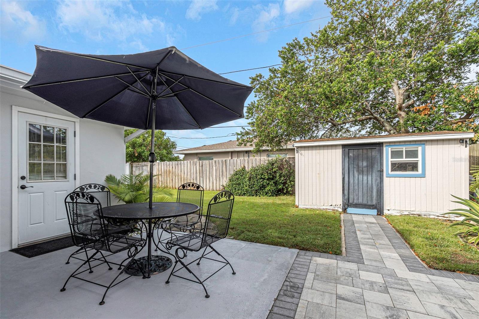 Backyard includes two storage sheds.