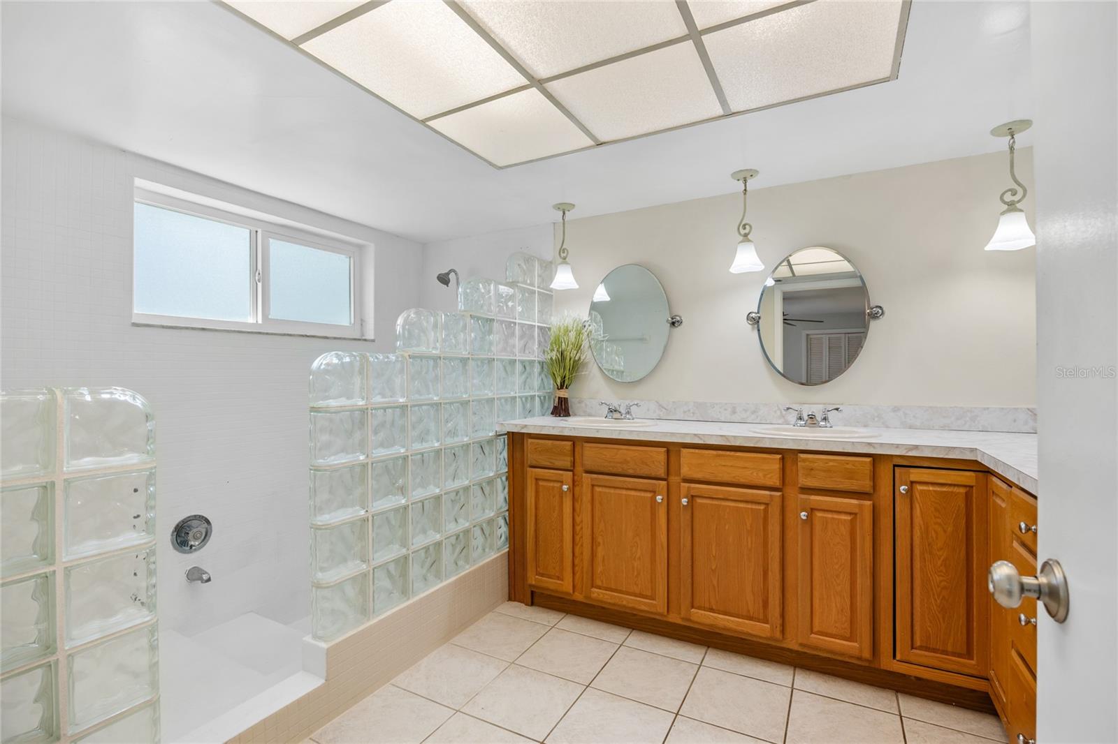 The Master Bathroom is generously sized, featuring an oversized double vanity with abundant storage, along with a spacious tiled shower for a truly luxurious experience