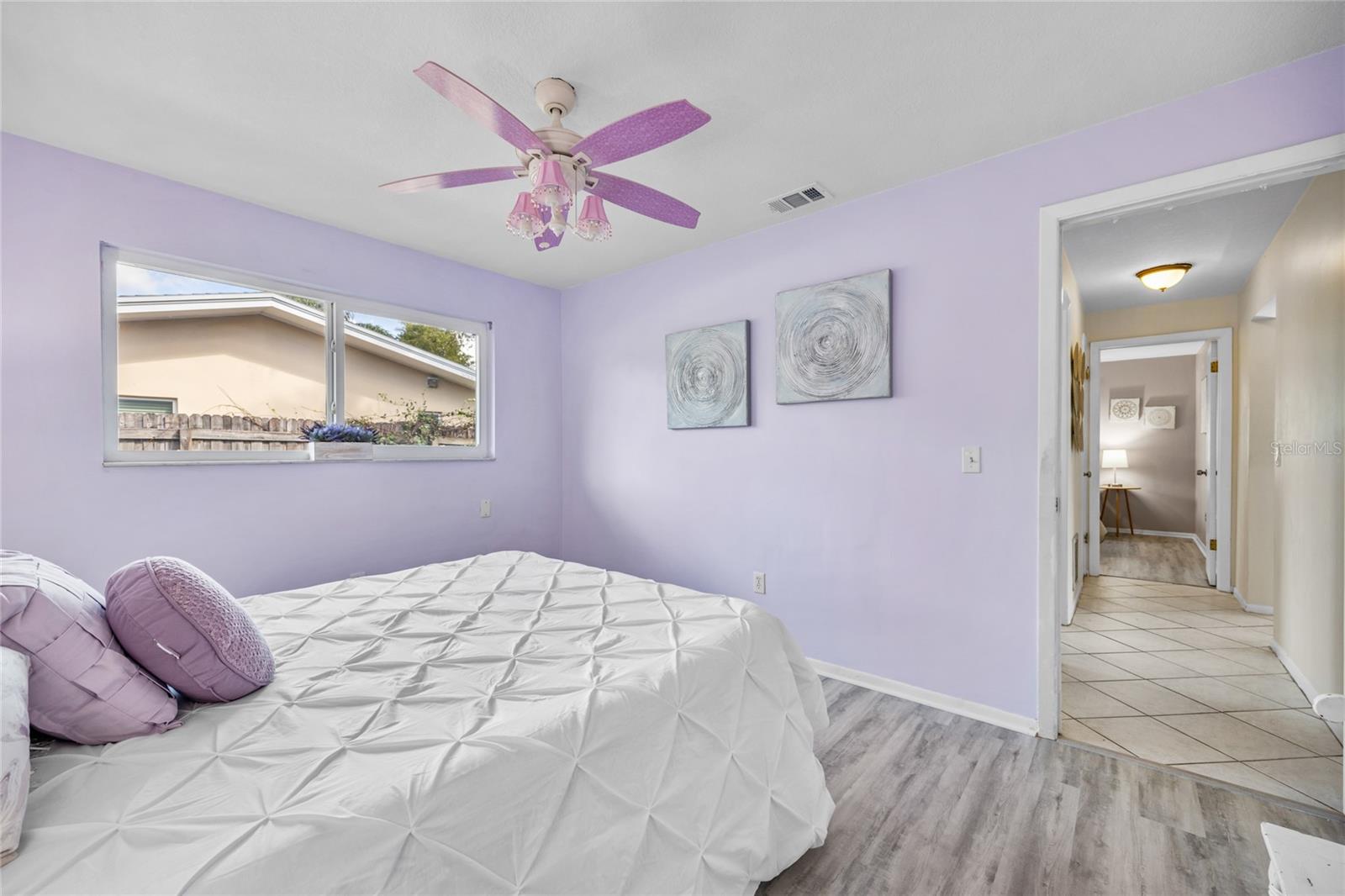 Bedroom #2 has a walk in closet, luxury vinyl flooring and a large window.