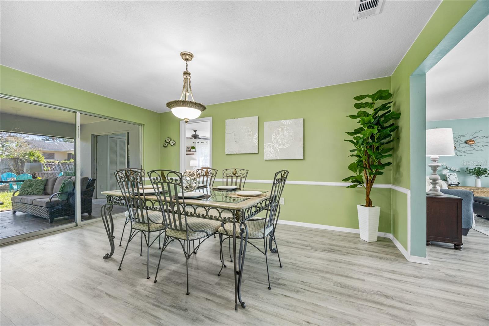 The formal dining room is ideally situated next to the kitchen, with easy access to both the formal living room and the screened lanai—an entertainer's dream for seamless flow and gatherings