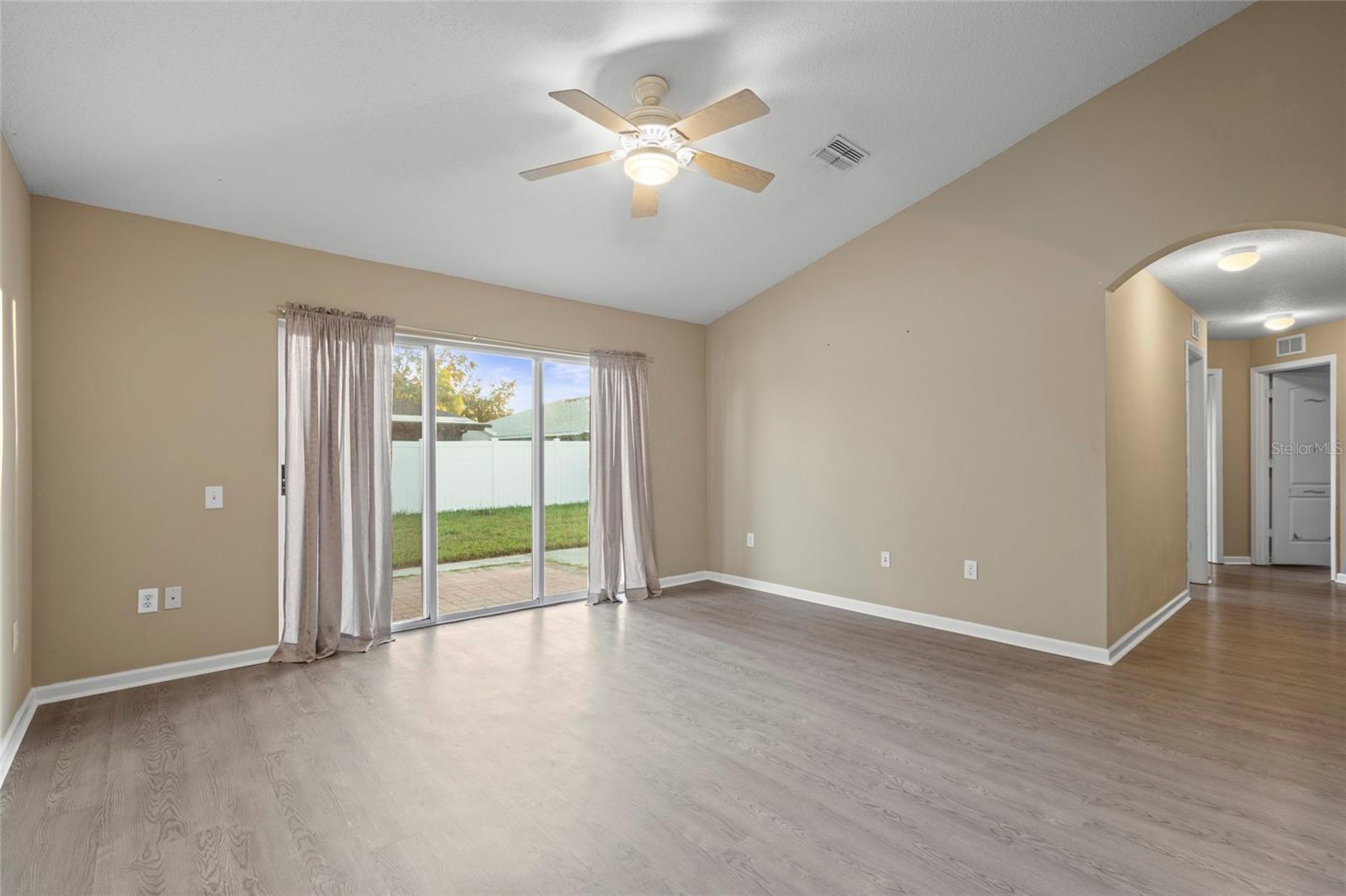 Family Room and Fenced in Backyard view