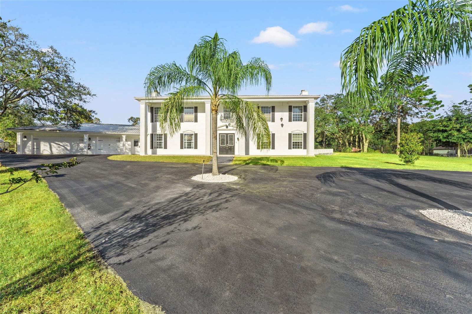 Colonial-inspired estate, designed with the grandeur reminiscent of the iconic “White House.” Set on a private 2.40-acre property