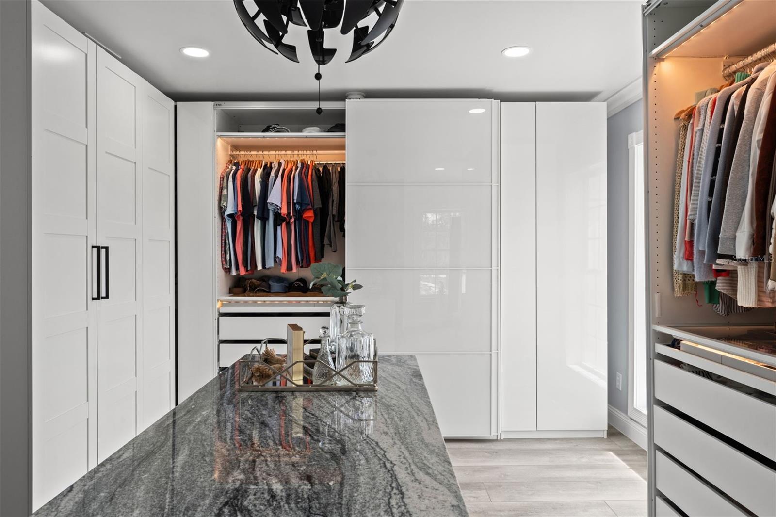 Master Suite Grand Walk-In Closet with a Central Island, Custom Wardrobes, and a Secure Armory Room