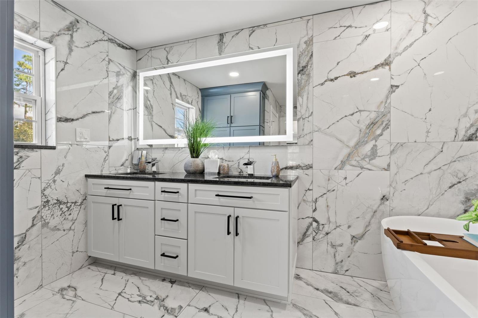 Spa-Like Master Ensuite with Dual Vanities, a Rainfall Shower, and a Garden Tub.