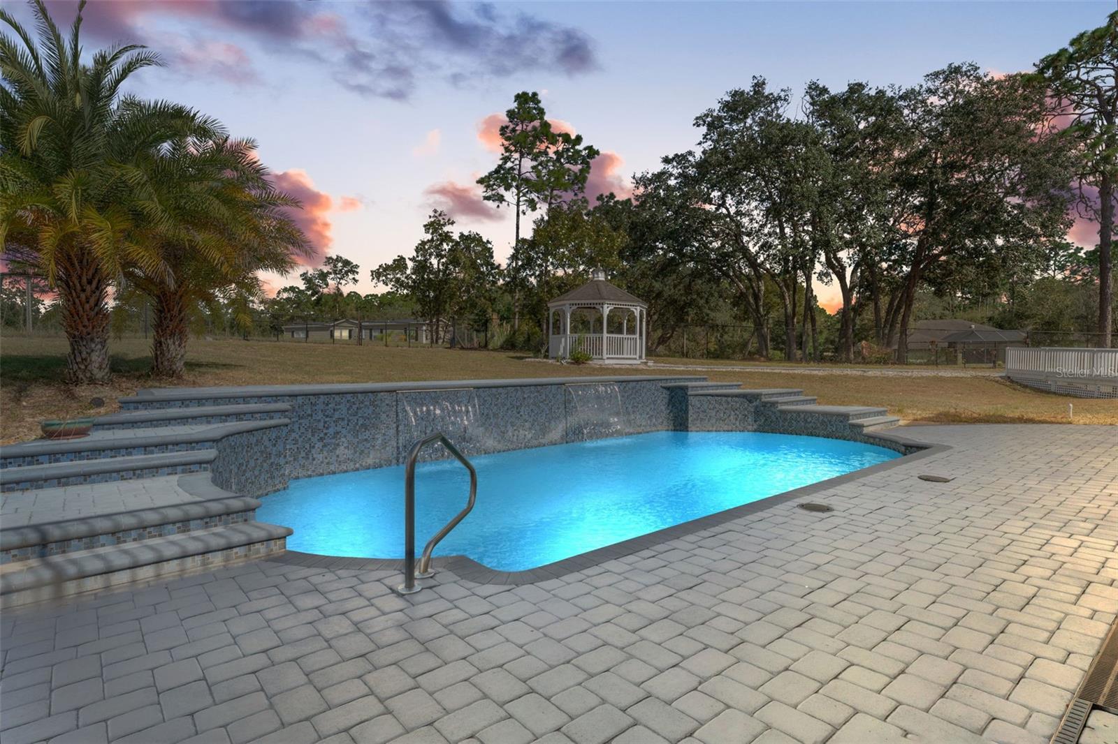 Heated Pentair pool with a tranquil waterfall