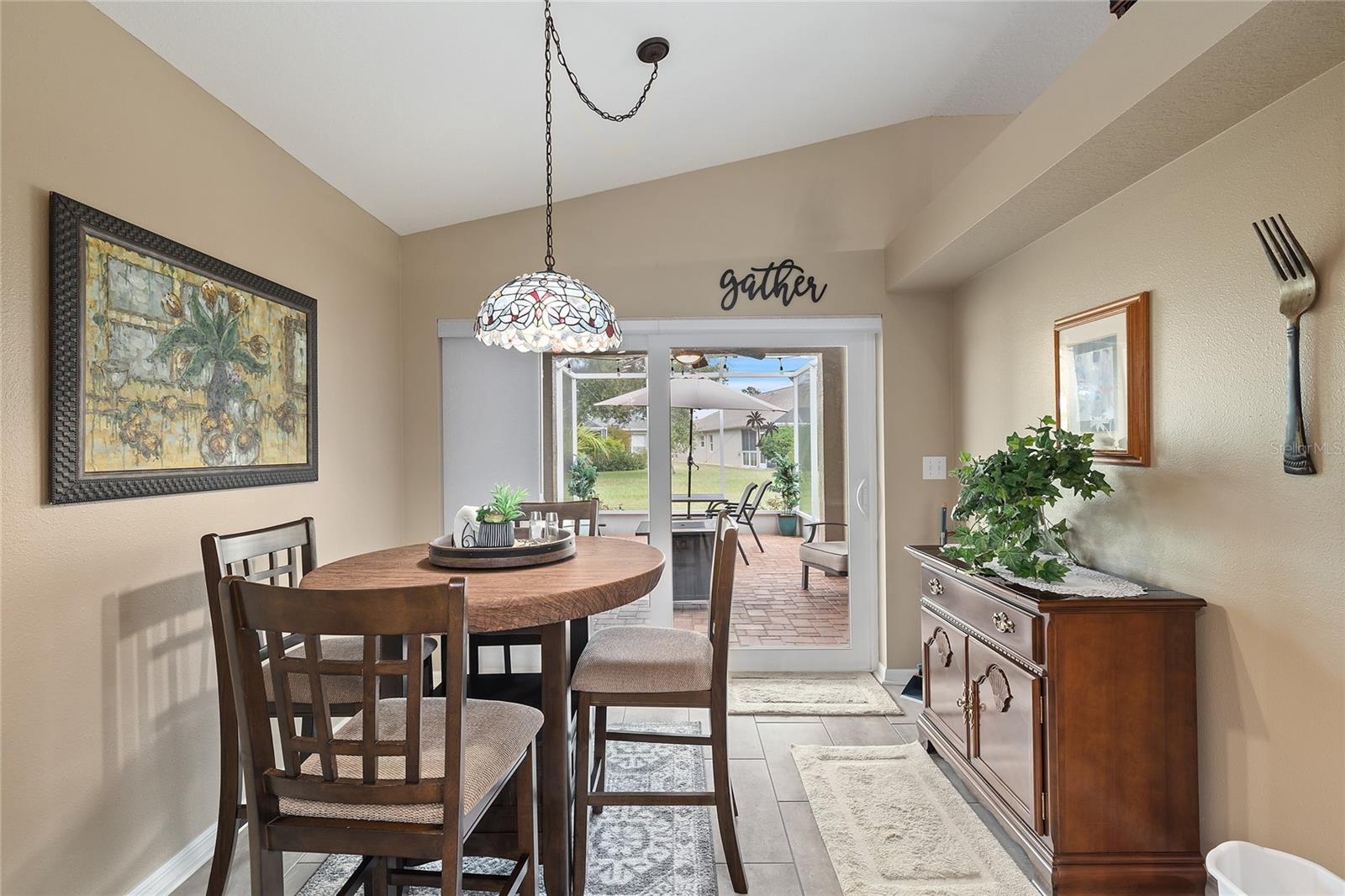 DINING ROOM WITH SLIDERS TO SCREENED PATIO