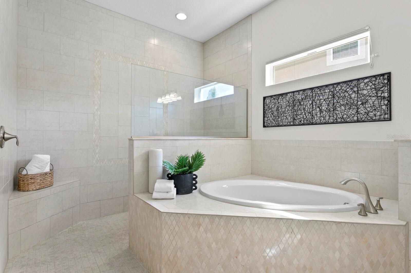 Relax in the garden bath or choose the spacious walk-in shower in the primary bath