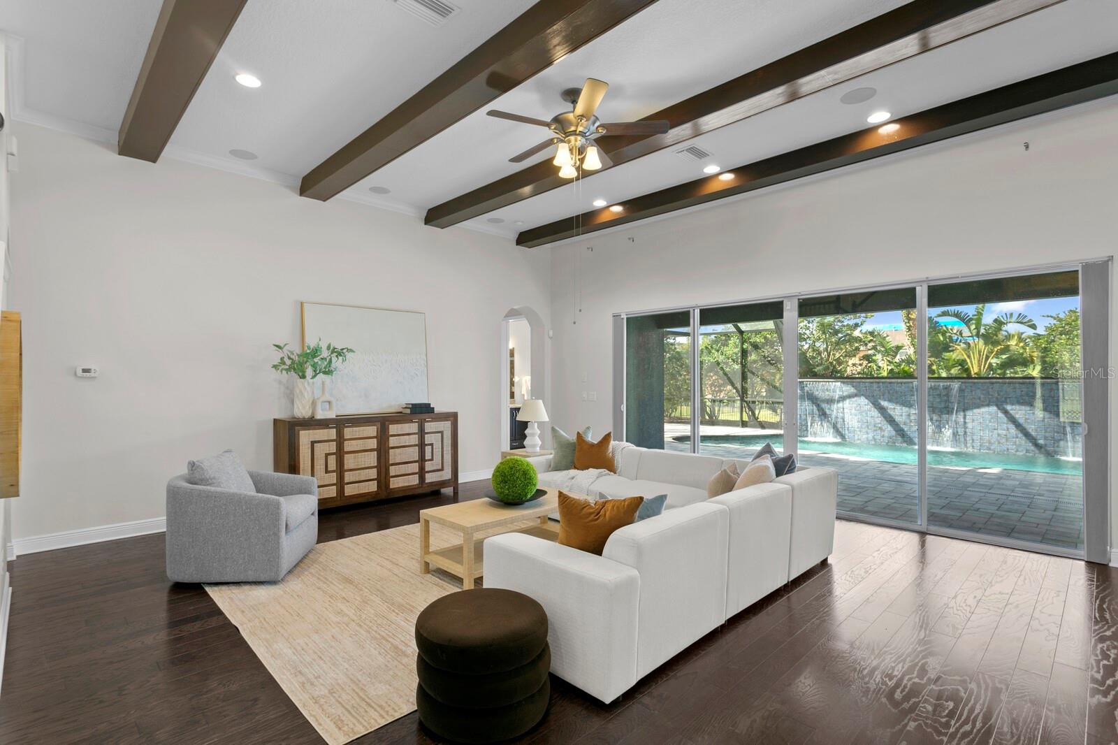 Quadruple sliding glass doors from the great room out to the private pool