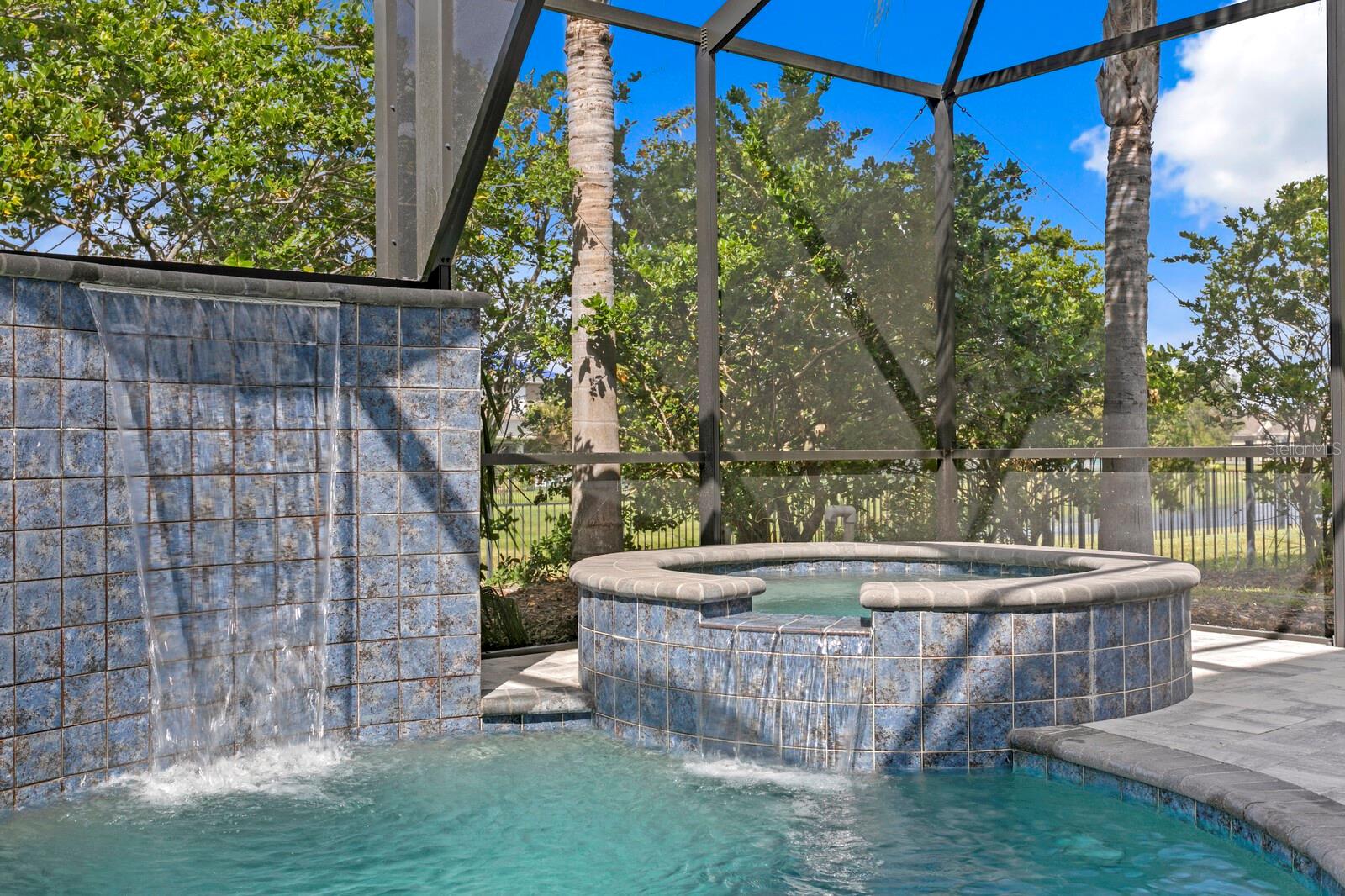 The Pebble Tec pool includes a spillover spa