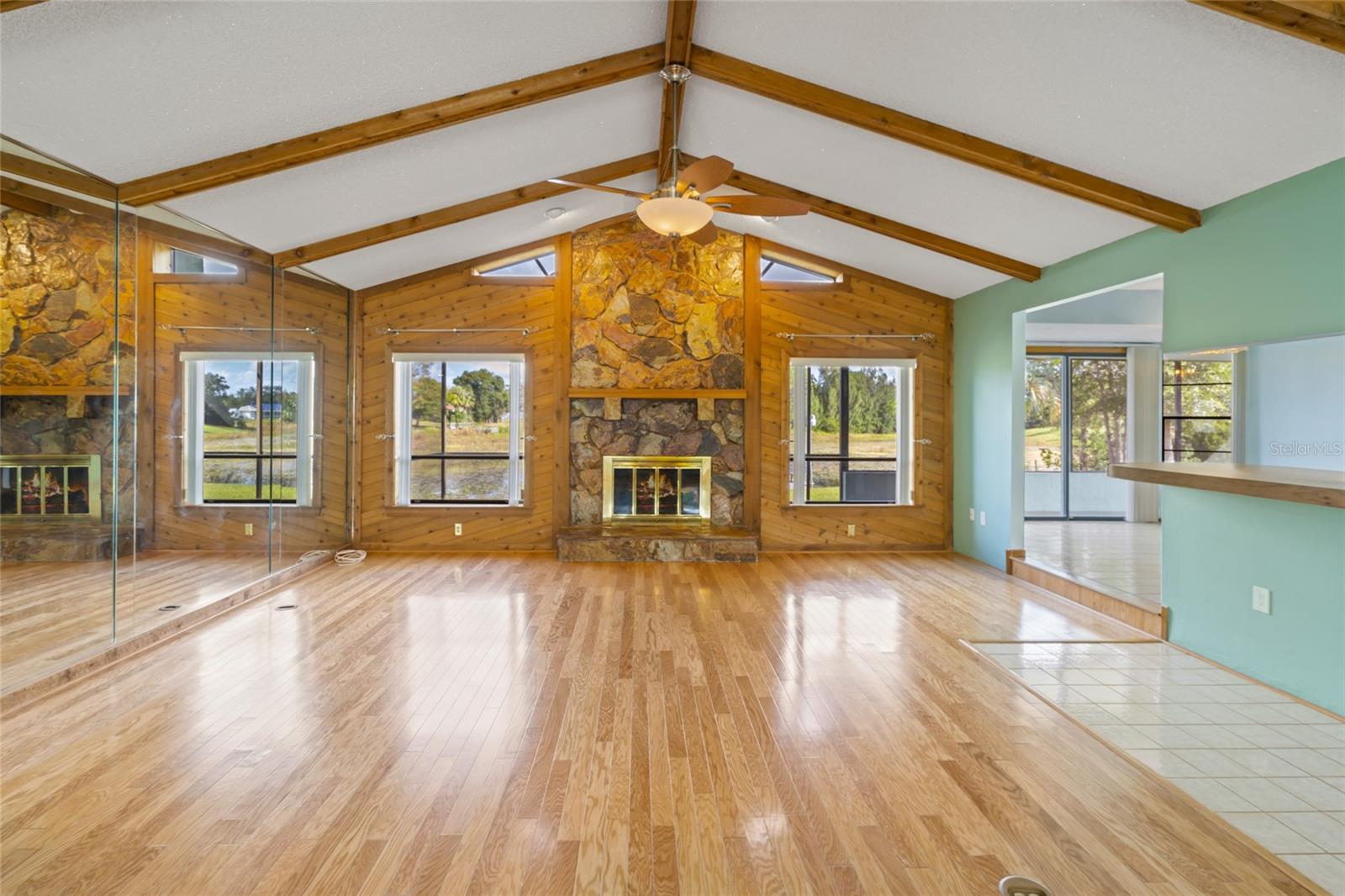 Great room wood floors and wood burning fireplace