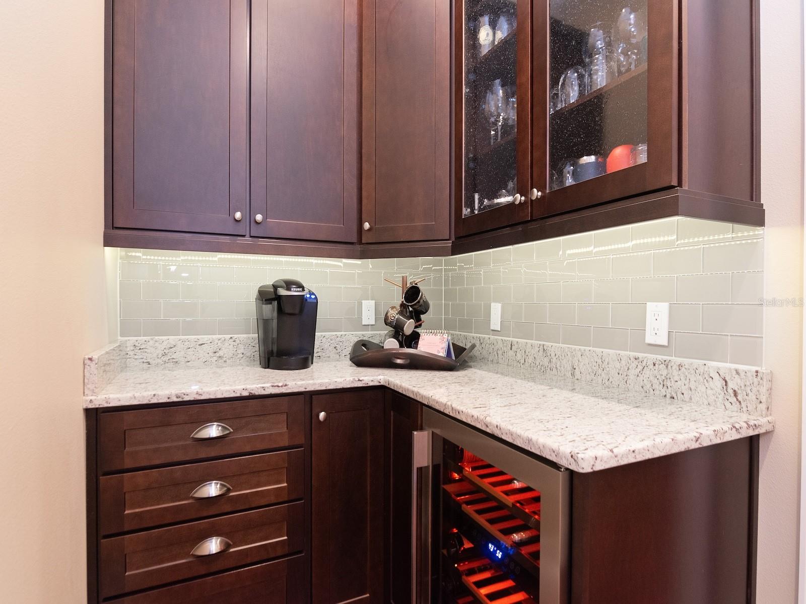 Butler's bar and walk in pantry link the kitchen and formal dining room.